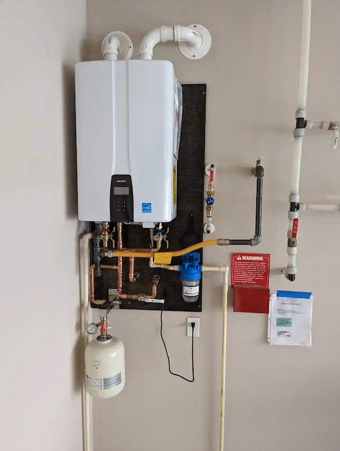 Professional plumber installing copper piping in a Haslet home